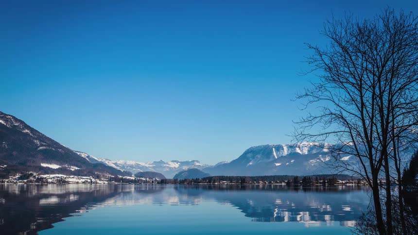 A lake stretches across a mountain valley