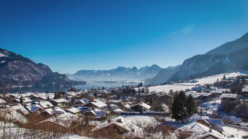 A snow covered town sits in a mountain valley