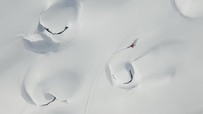 A person skins across a snowy landscape