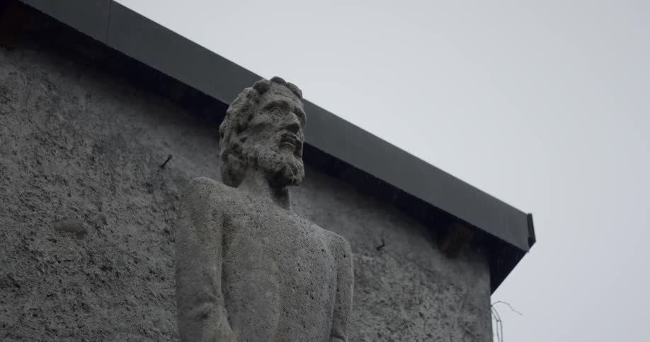 A statue sits near the edge of the building