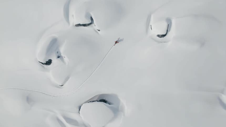 A person walks through the snow on skis