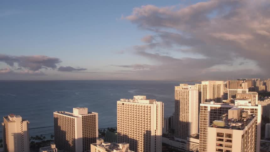Skyline of the city next to the sea with cloudy sky during daylight