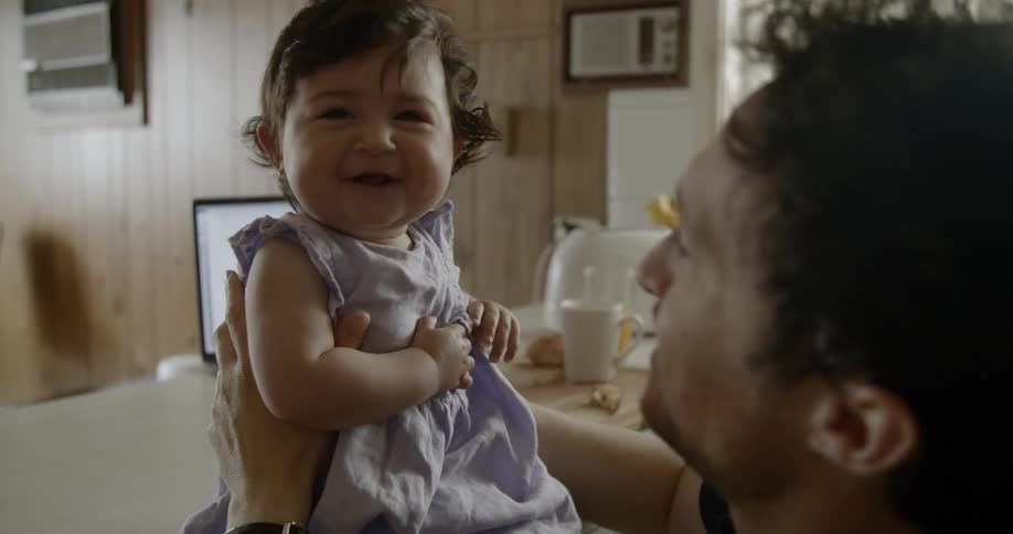 A young girl gets kisses from her father