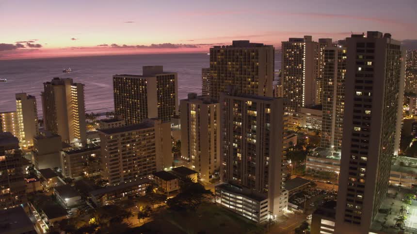 The skyline of a metropolis new the ocean at sunrise