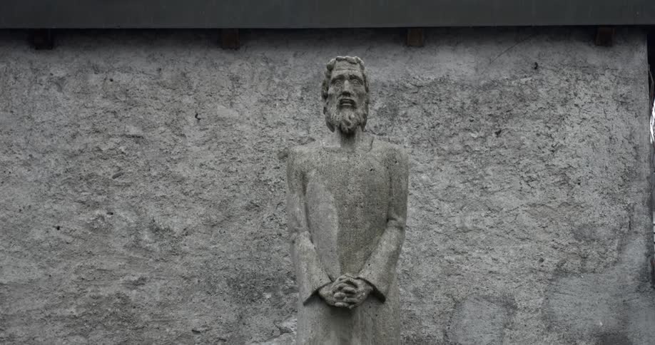 Figure carved into stone wall of building