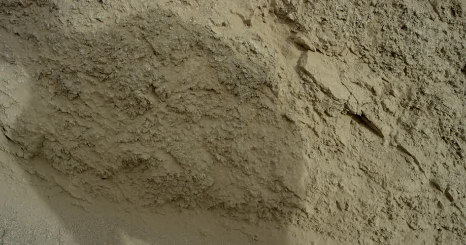 A person walking through the sand