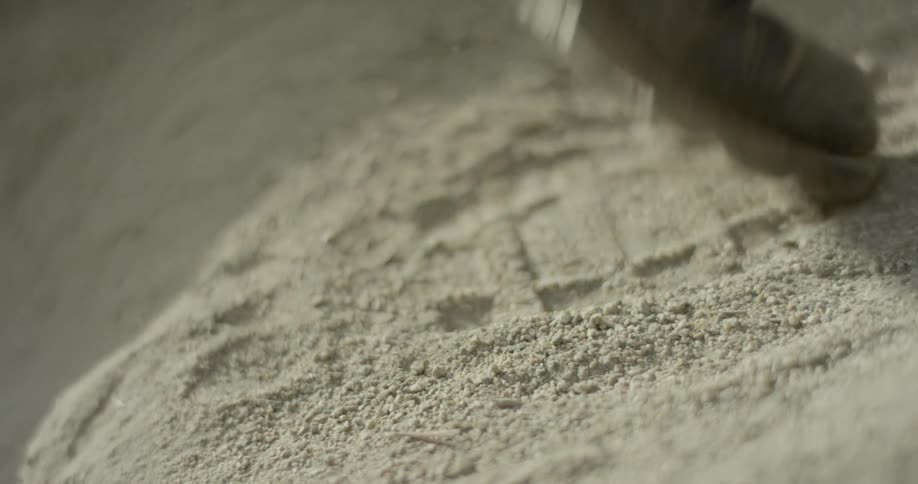 A person walks up a sandy hill