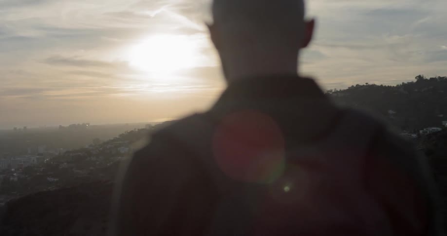 A man looks out over a city
