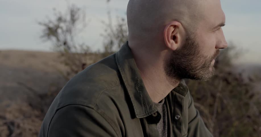 A man is outdoors watching the horizon