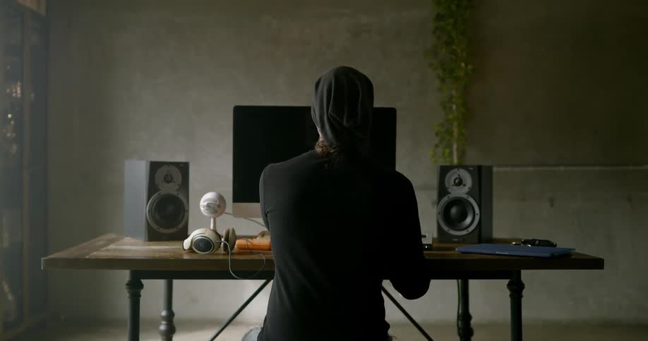 Man works on keyboard at desk