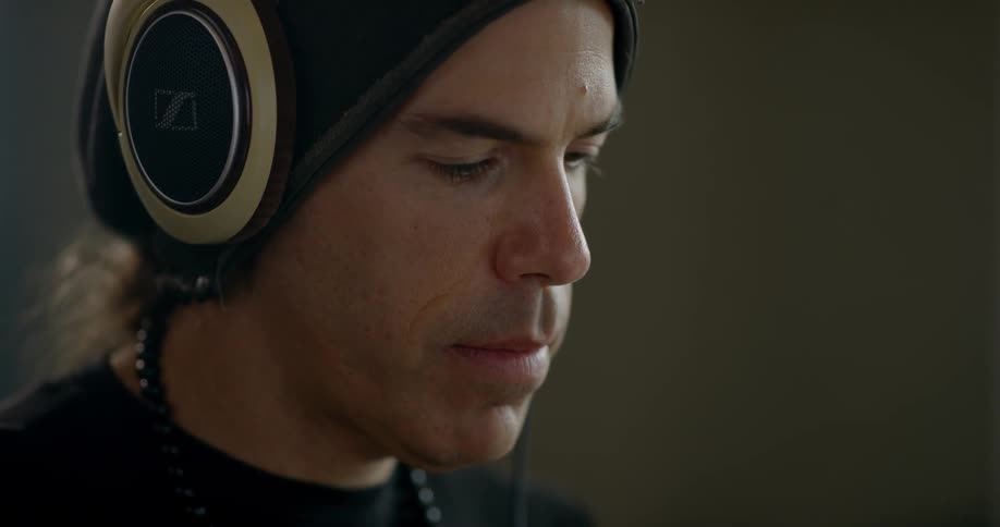 A man is wearing headphones indoors