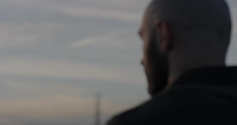 Silhouette of a man looking towards the city