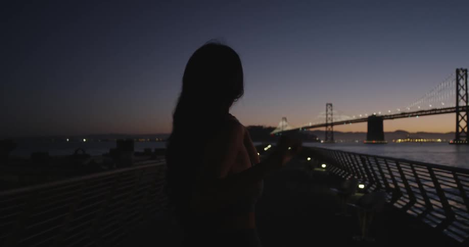 Woman stretching ready to jog on a bridge at sunset