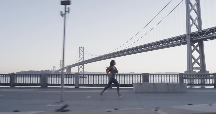 A woman runs along the waterfront