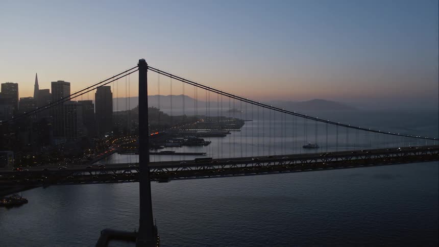A bridge over water with the city in the background