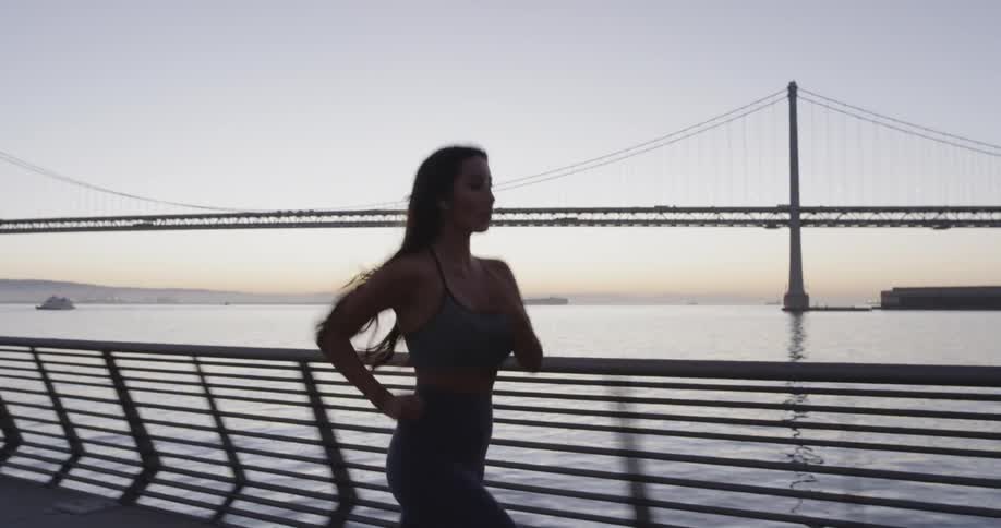 A woman runs on the bridge