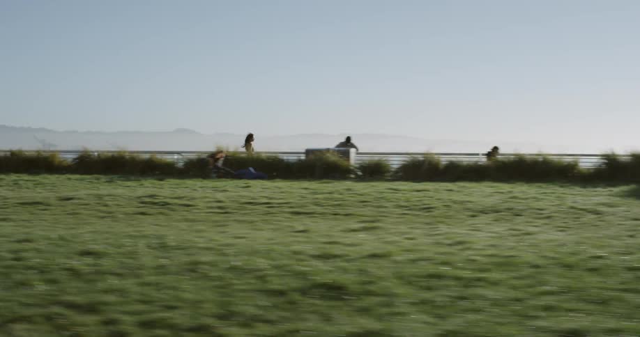A woman runs on a path high above the coast line