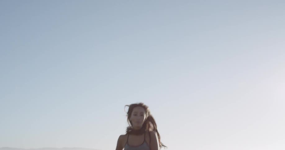 An asian woman is running and smiling