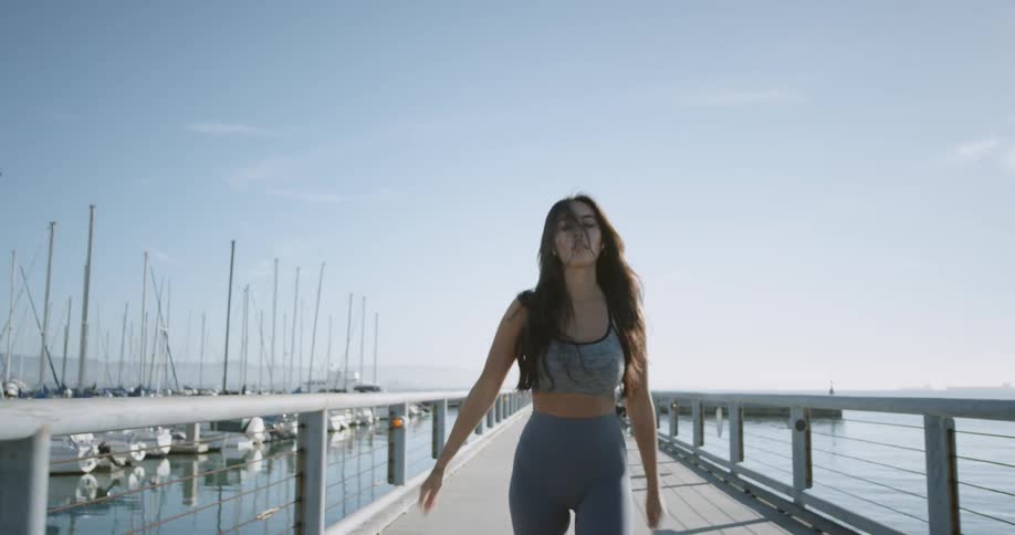 A woman stretches on the pier