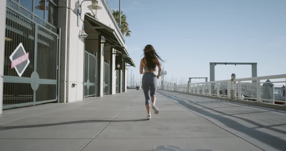 Woman jogging near businesses