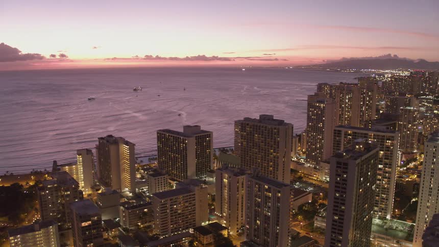 A large city on the shores of a lake during sunrise
