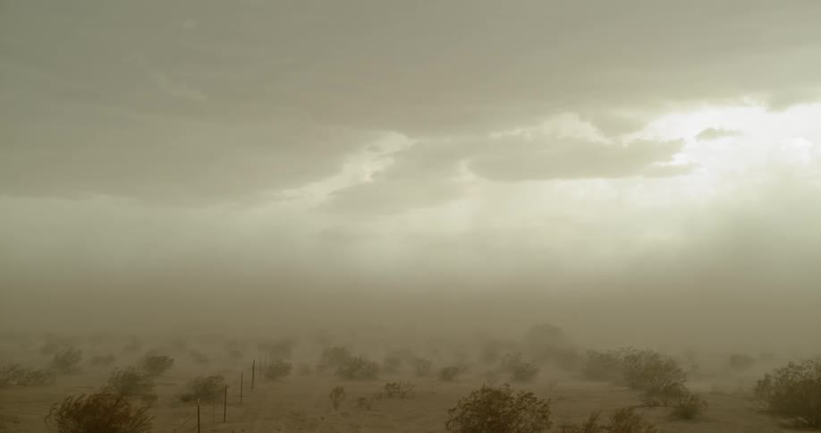 A dust storm covers a desert landscape