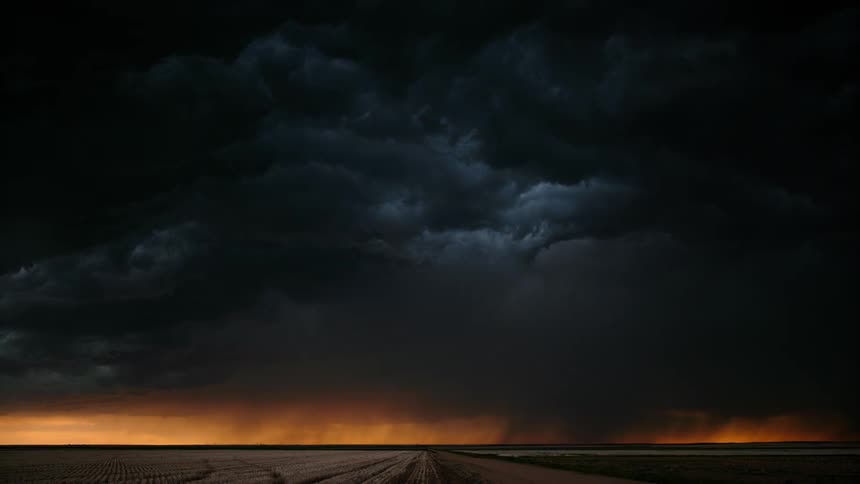 A wide shot of a thunderstorm at dusk