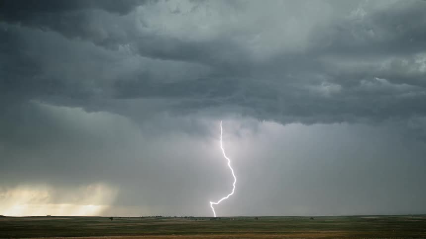 Lightning strike the ground during storm over fields
