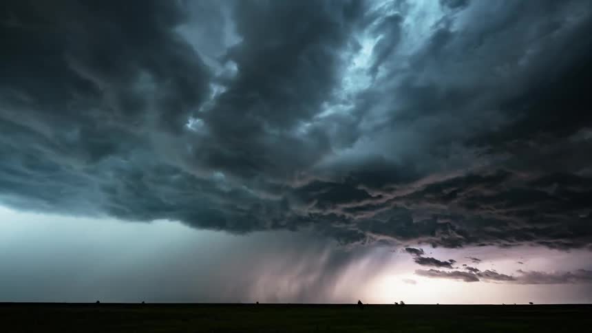 Lightning flashing in rolling storm clouds over a plain