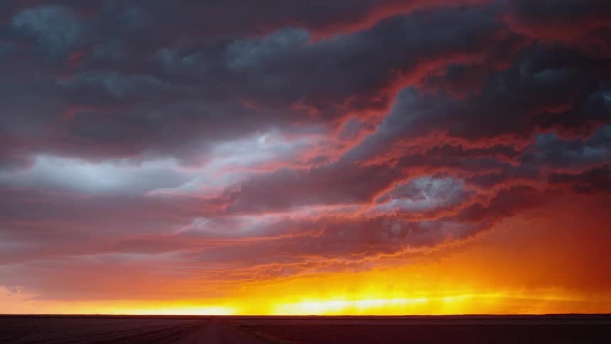 A wide shot of storm clouds at sunset