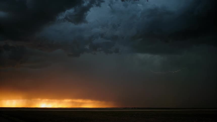 Lightning strikes as dark clouds cover the horizon