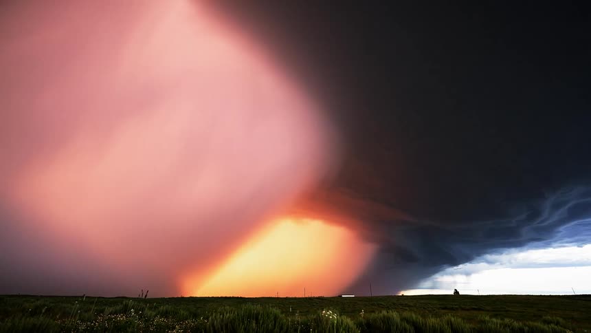 Tornado formation storm front flows across countryside
