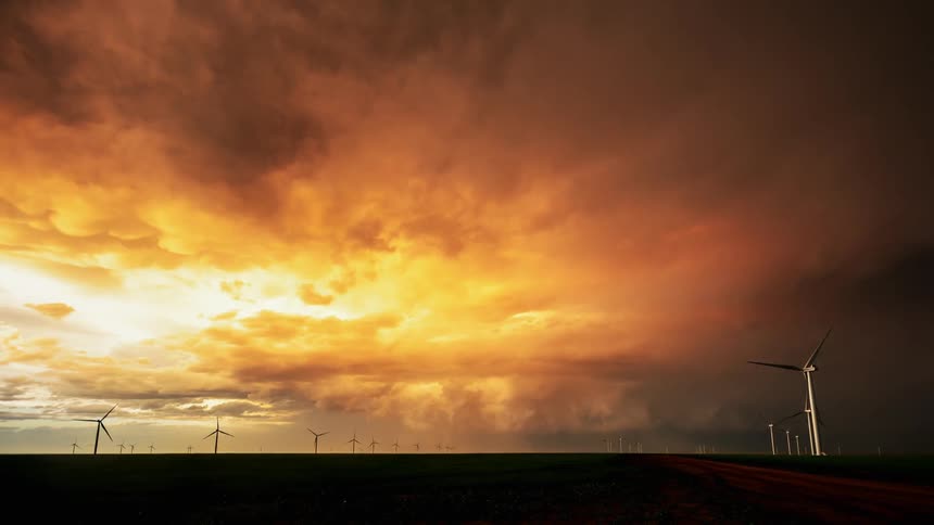 Storm clouds move over wind turbines in a wind farm