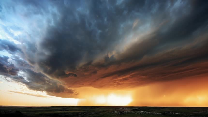 Tornado formation over fields near town