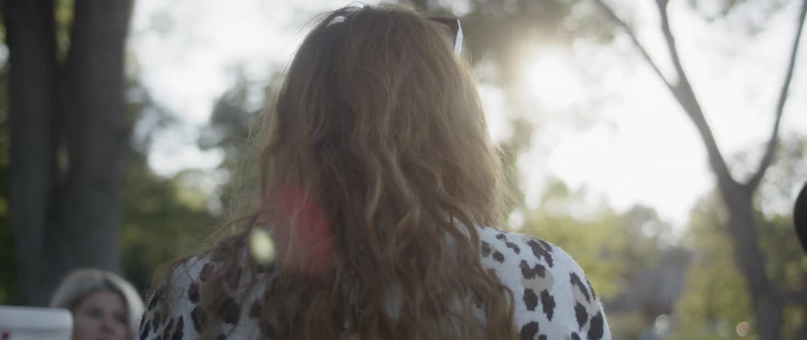 Woman talks to women in the public park while the sun shines