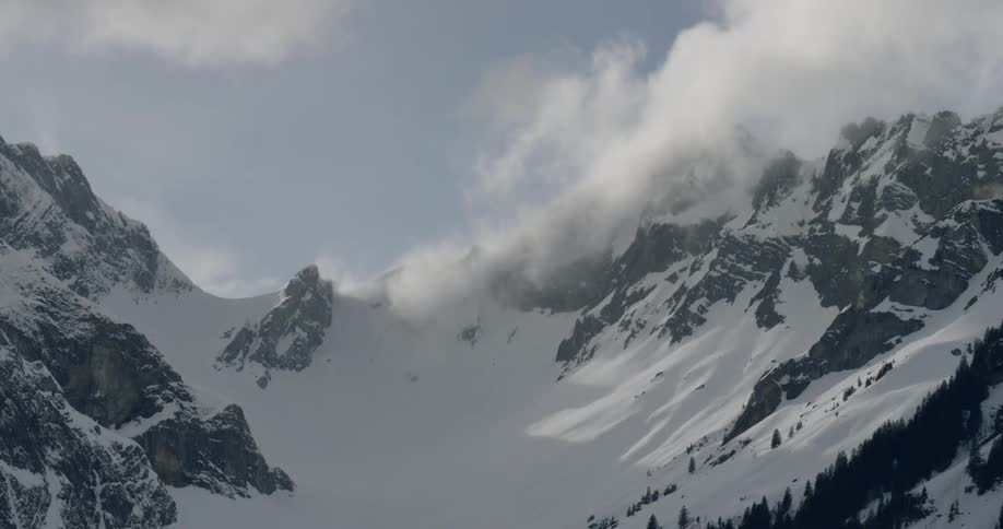 Clouds move above a mountain range