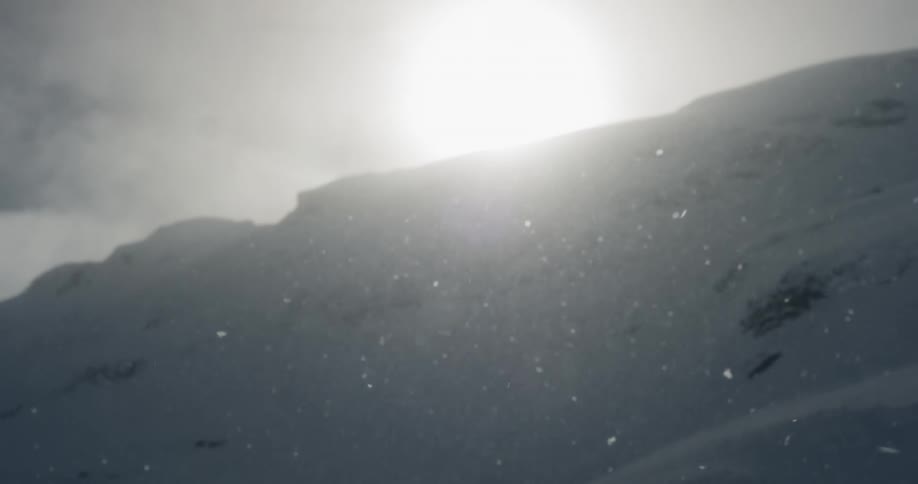 Snow falls over the mountain