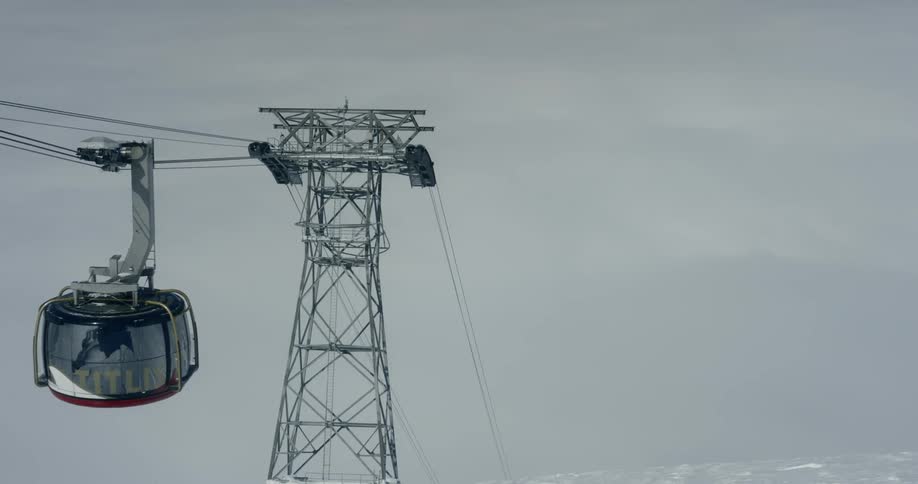 A ski lift glides down a cable line