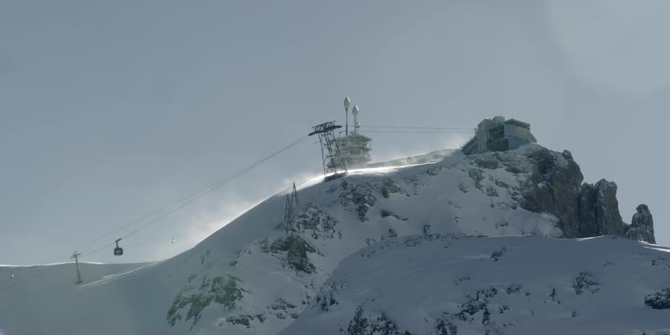 A ski lift goes up the side of a mountain