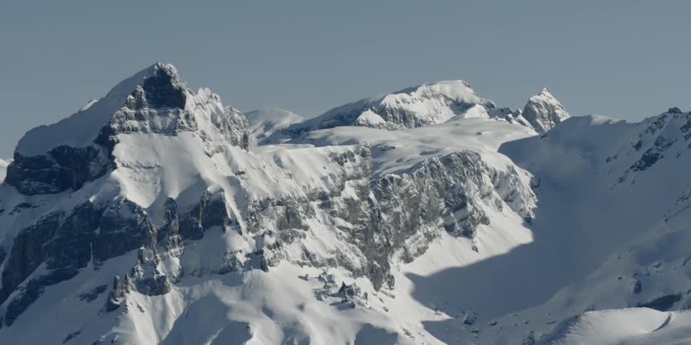 Ice forms on the peaks of snow covered mountains