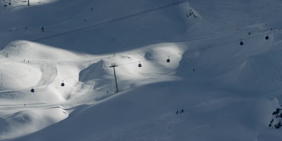 Gondola lifts traveling up and down a ski course