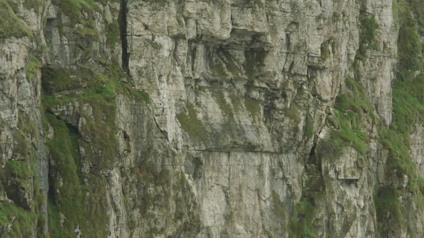 The camera slowly wanders down the cliff like a mans eyes appreciating a beautiful woman