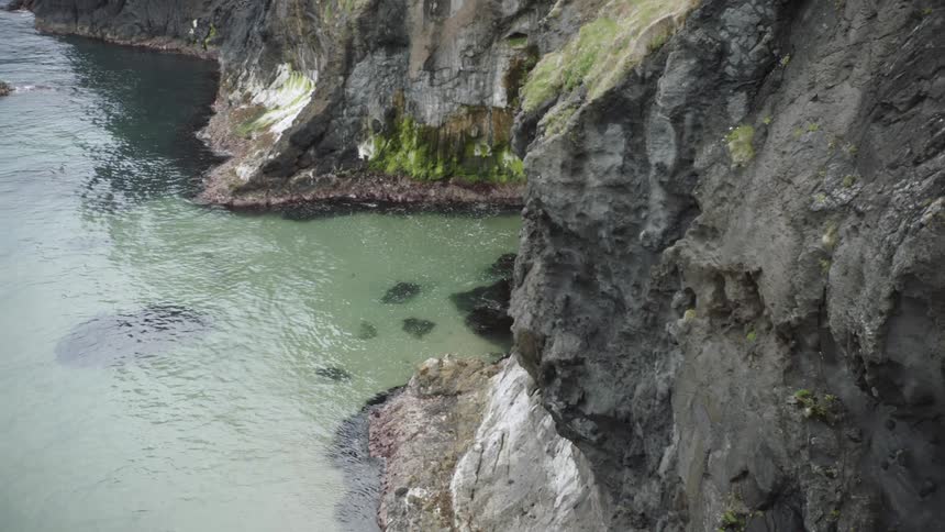 Waves are moving towards the cliff shoreline