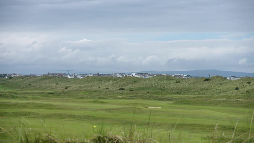 Landscape view of a field with mountains in the background