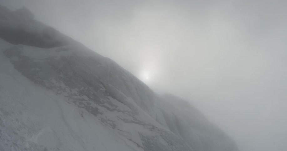 The side of a mountain is covered in snow
