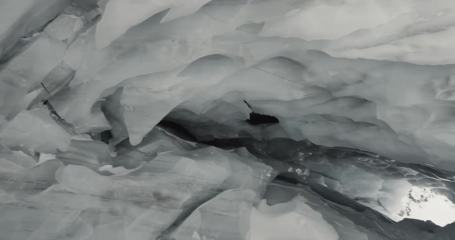 Sunlight streams through ice cave entrance