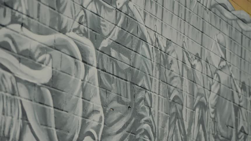 A mural painting on a brick wall