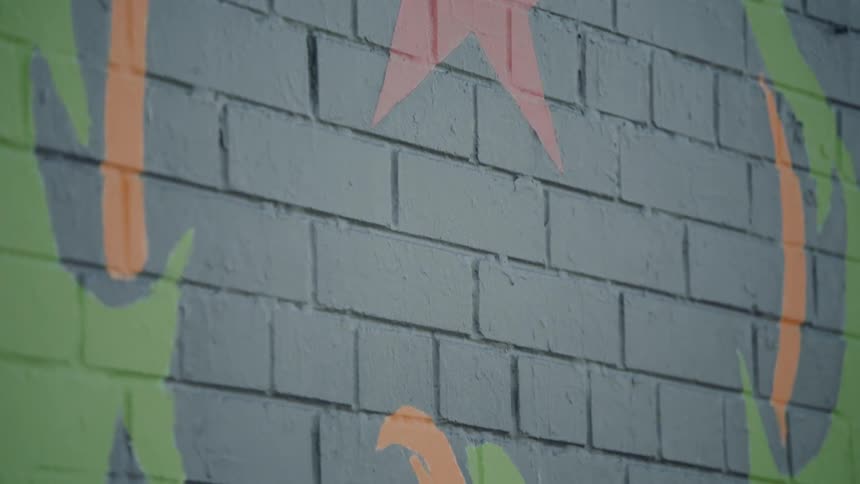 A symbol with a red star painted on a brick wall