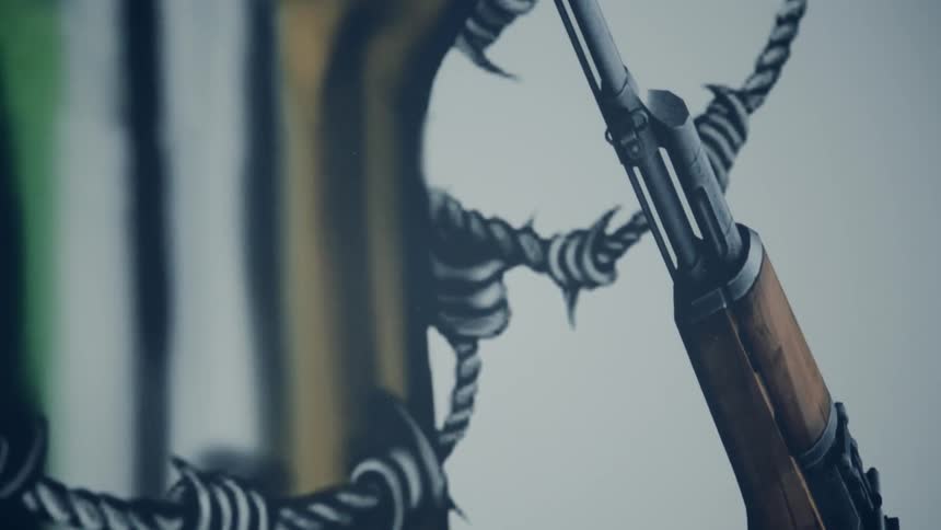 A painting of a rifle barrel leaning against barbed wire