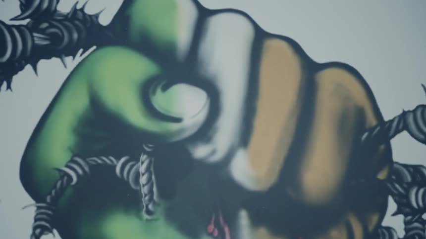 A mural of a closed fist grasping barbed wire